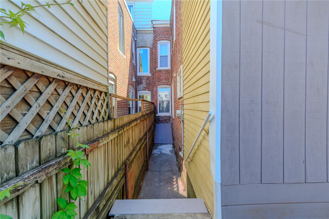 820 North 5th Street Allentown, PA 18102 - Photo 36 of 39 A fenced pathway offers private access between the buildings, leading to an obscured entrance.