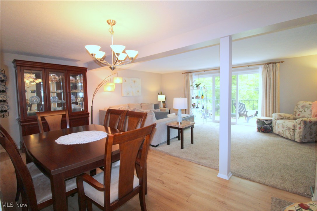 6478 State Road, Unit G8 Cleveland, OH 44134 - Photo 12 of 36 Dining Room with LTV Flooring, Modern Neutral Paint and Light Fixture Open to Living Room