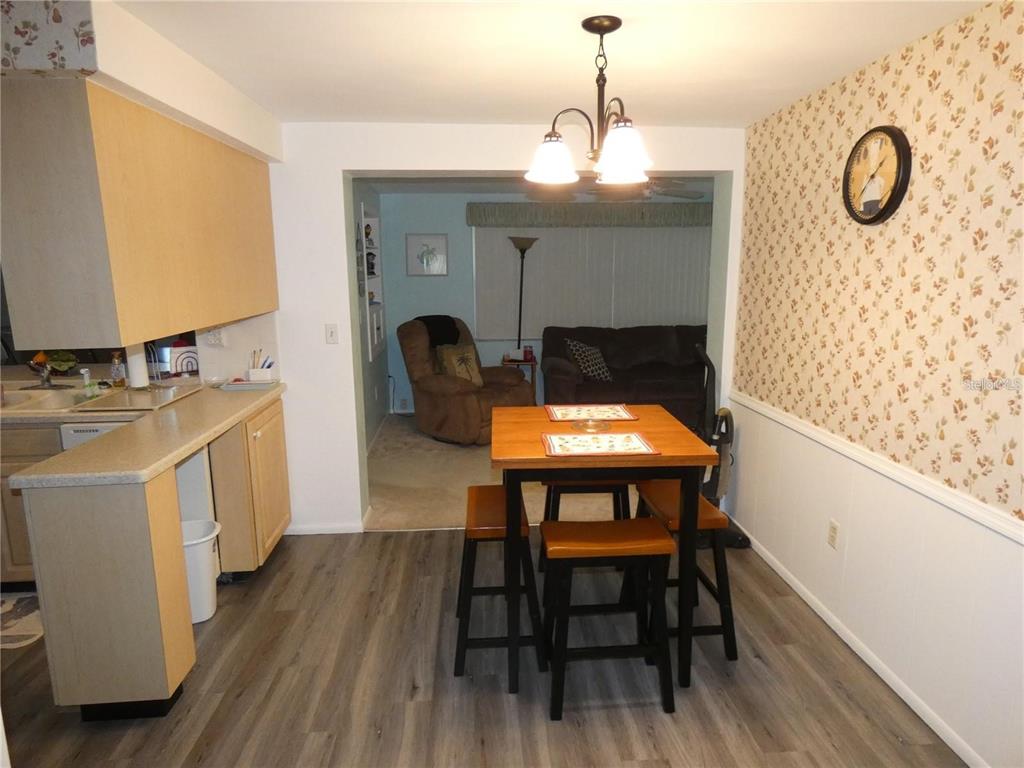4392 Craftsbury Drive New Port Richey, FL 34652 - Photo 12 of 41 a view of a dining room with furniture window and wooden floor