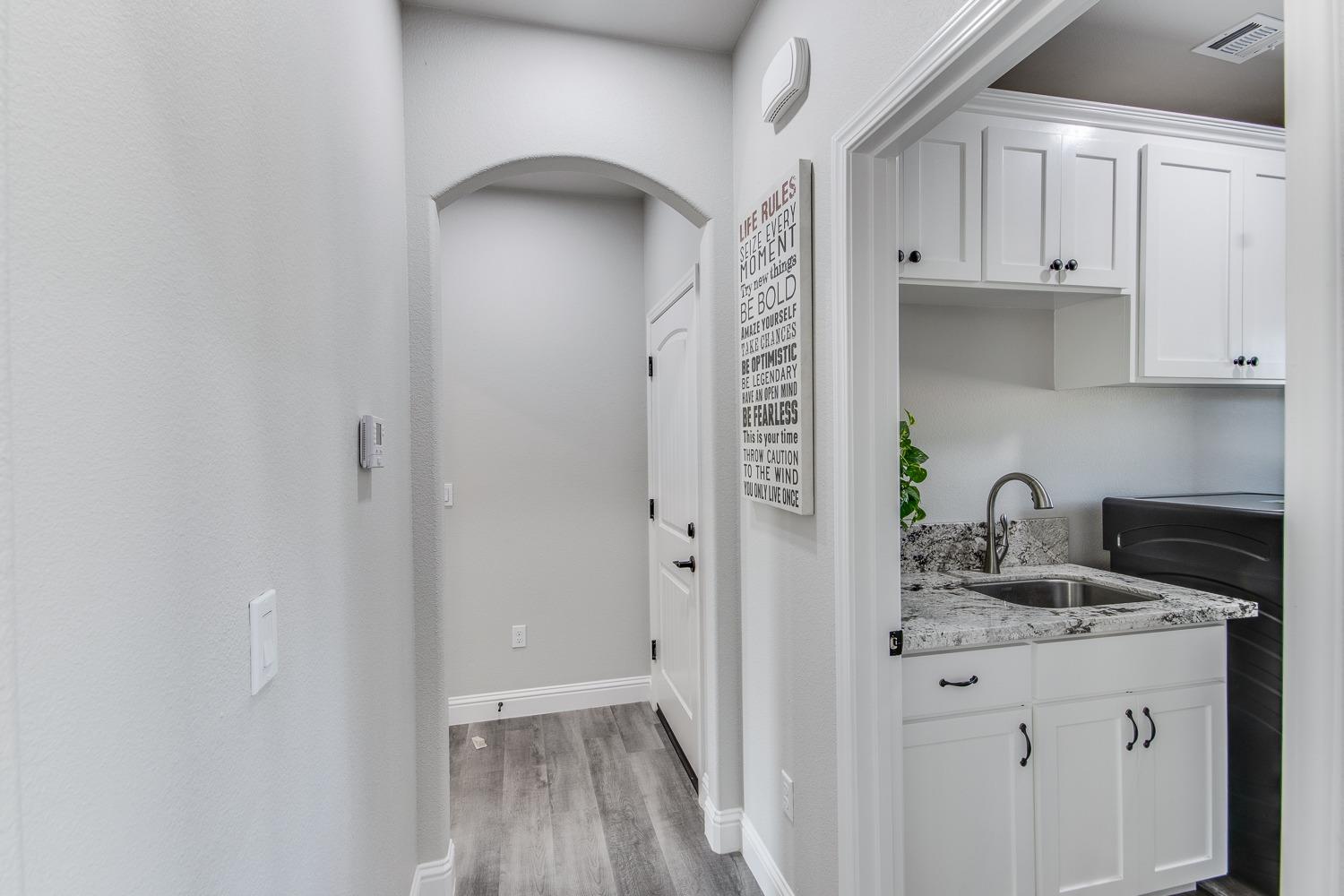 16639 Mark Road Madera, CA 93636 - Photo 12 of 33 a kitchen with granite countertop white cabinets and a sink