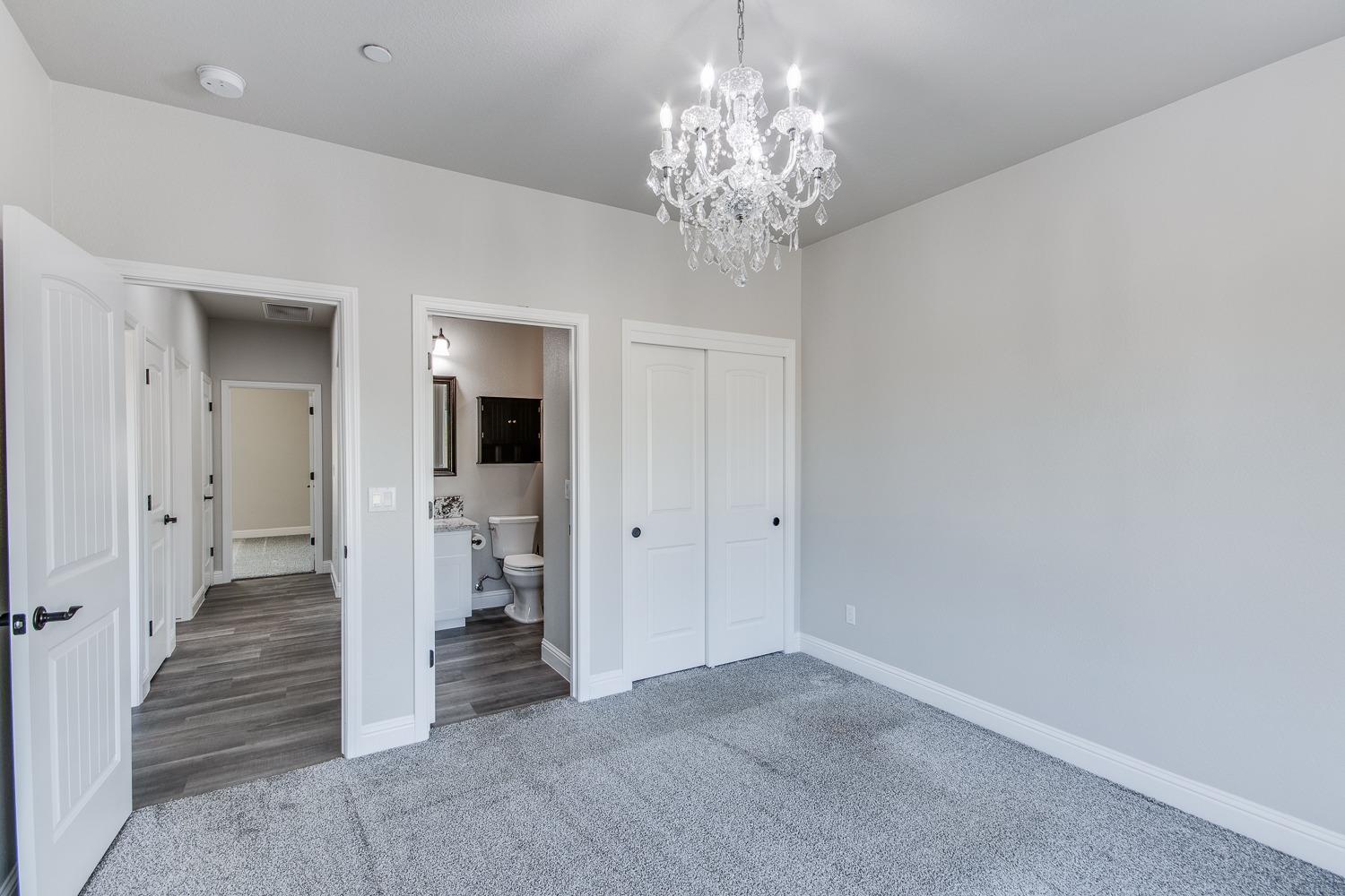 16639 Mark Road Madera, CA 93636 - Photo 14 of 33 wooden floor in an empty room with a chandelier