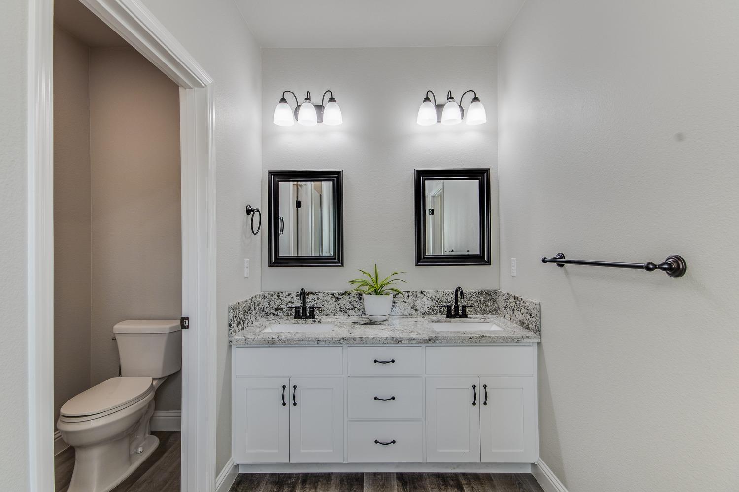 16639 Mark Road Madera, CA 93636 - Photo 21 of 33 a bathroom with double sink and a toilet
