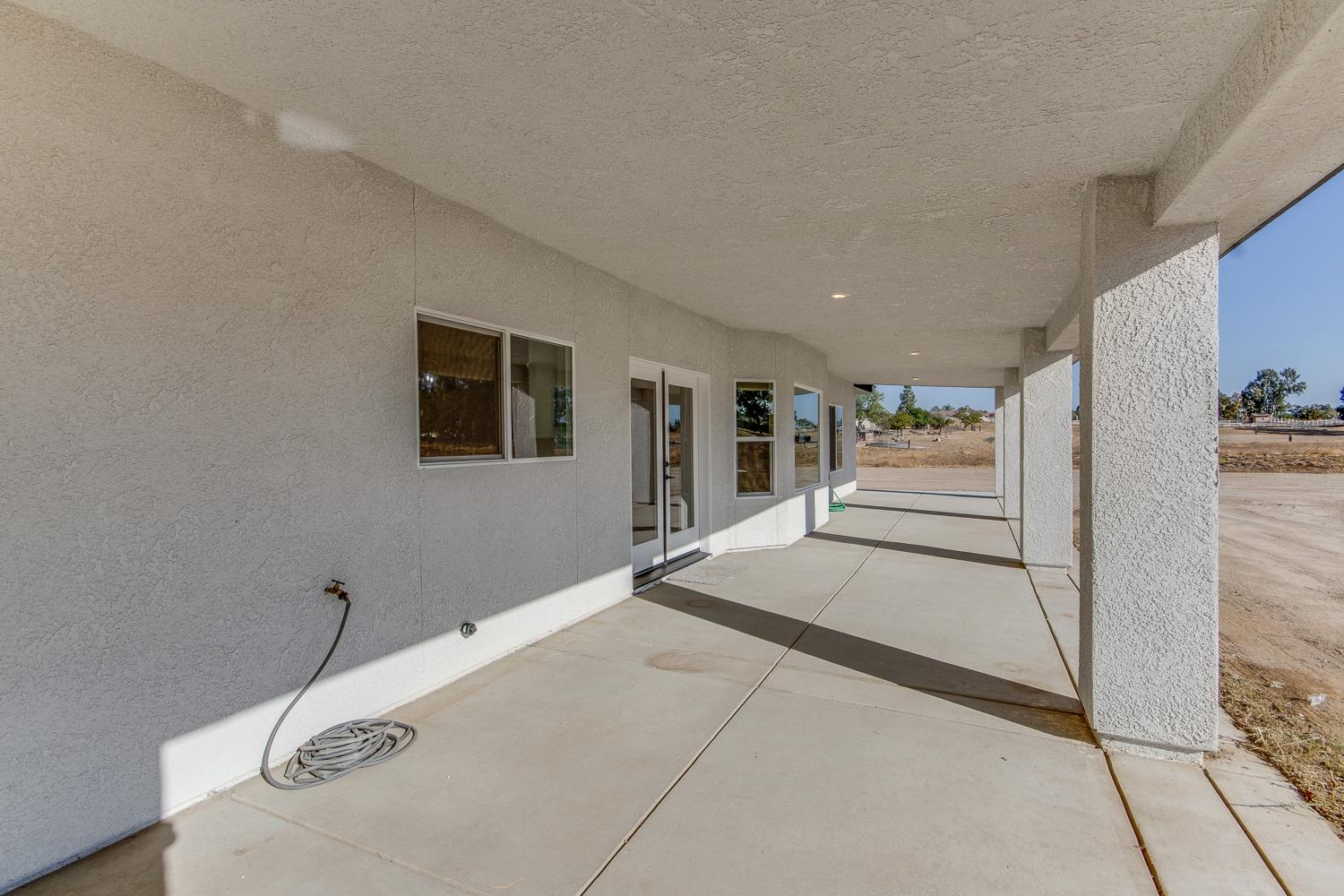 16639 Mark Road Madera, CA 93636 - Photo 24 of 33 a spacious bedroom with a bed and a walk in closet