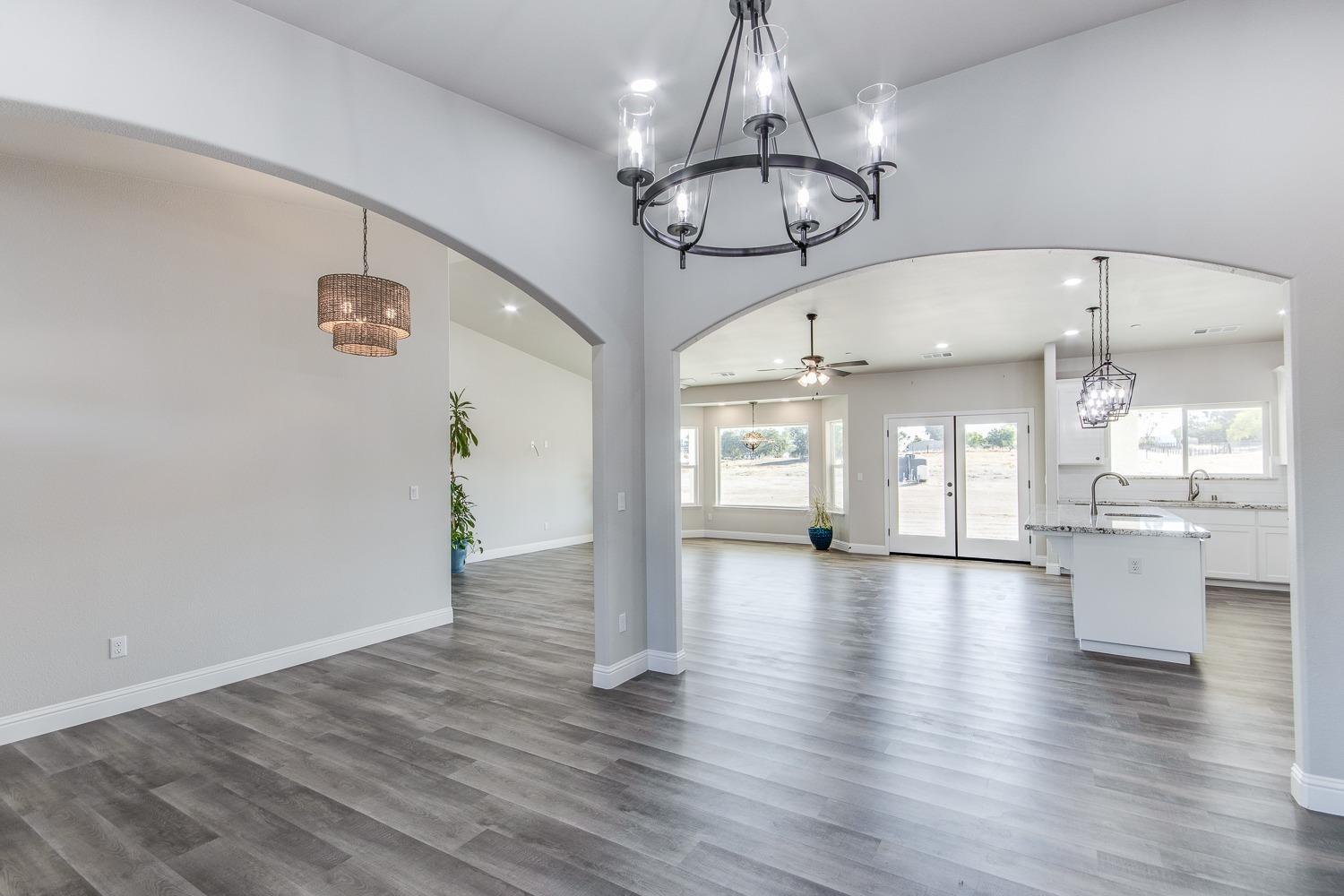 16639 Mark Road Madera, CA 93636 - Photo 4 of 33 a view of a room with wooden floor water heater and kitchen view
