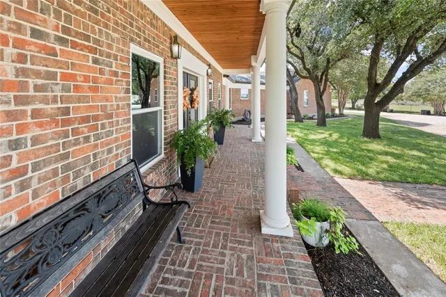 a view of a house with backyard sitting area and garden