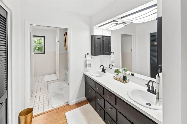 a kitchen with granite countertop a table chairs stove and refrigerator