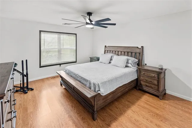 a bedroom with bed and a chandelier