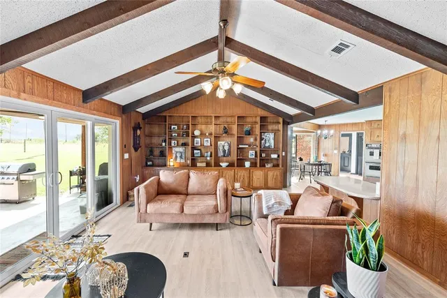 a bedroom with a bed a flat screen tv and a couch