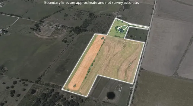 an aerial view of a house with a garden and lake view
