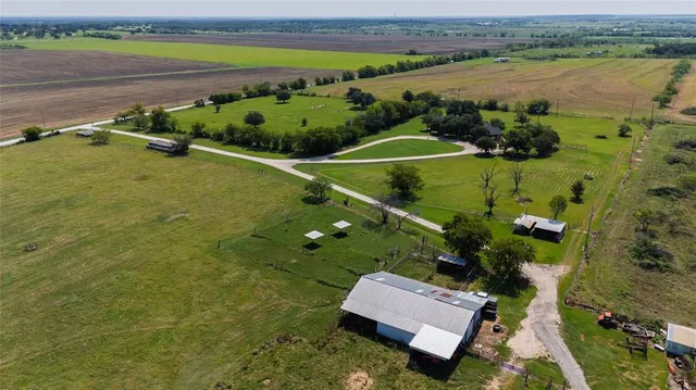an aerial view of a residential houses with outdoor space