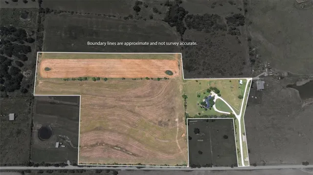 an aerial view of a house with a garden and lake view