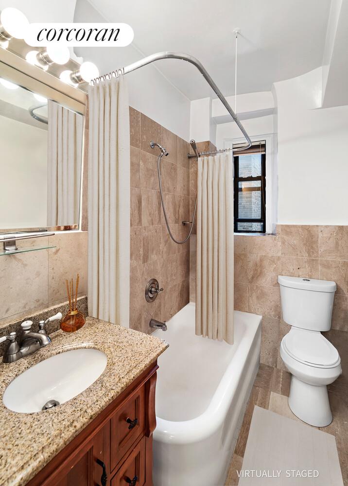 142 East 49th Street, Unit 9E Manhattan, NY 10017 - Photo 5 of 6 a bathroom with a granite countertop sink toilet and shower