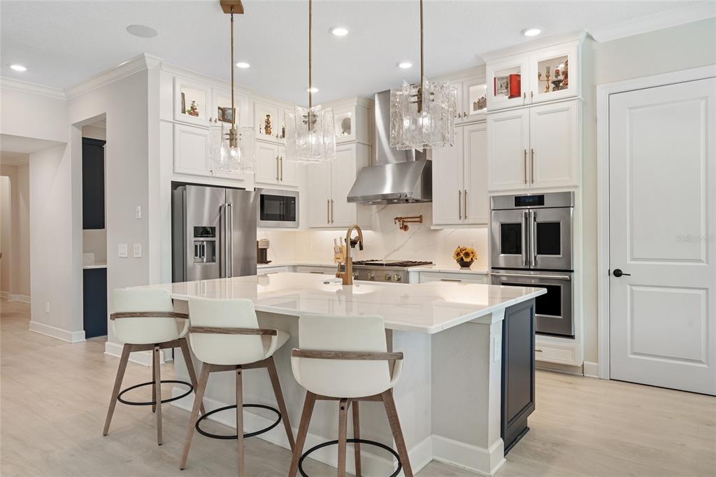 10175 Brocksport Circle Gotha, FL 34734 - Photo 10 of 54 a large kitchen with stainless steel appliances kitchen island granite countertop a table and chairs in it