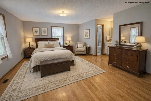 a living room with a bed and a dresser