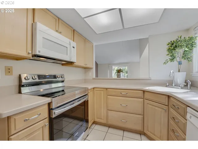 a kitchen with a refrigerator and a sink