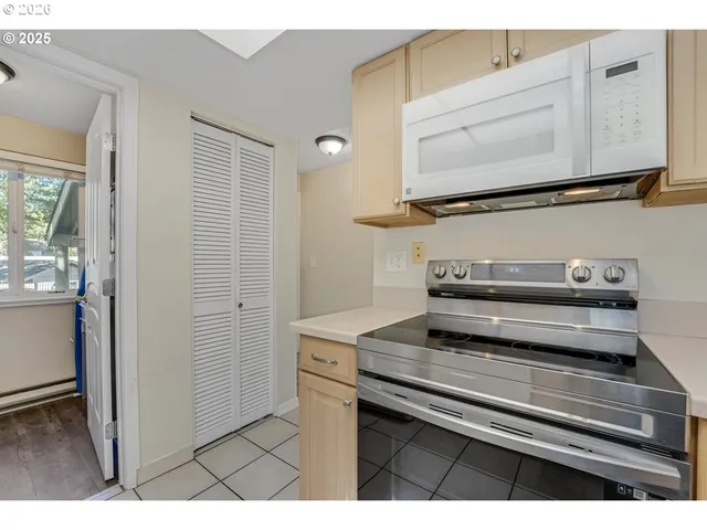 a kitchen with stainless steel appliances a refrigerator sink and cabinets