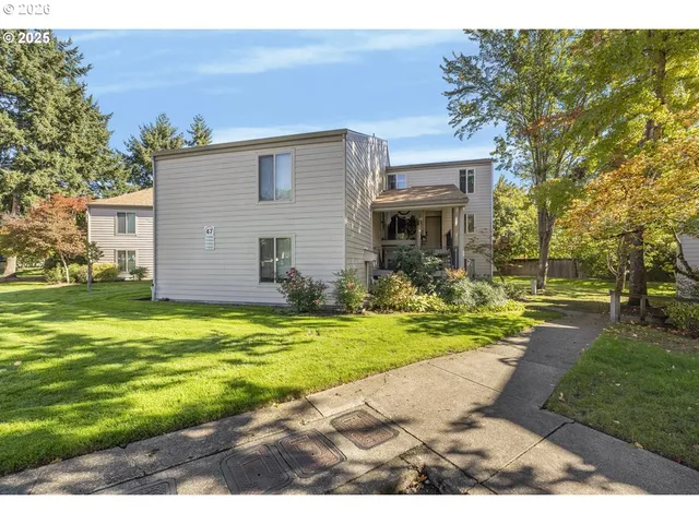 a view of an house with backyard space and balcony