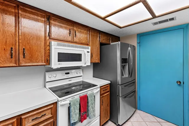 a kitchen with stainless steel appliances a microwave a stove and a refrigerator