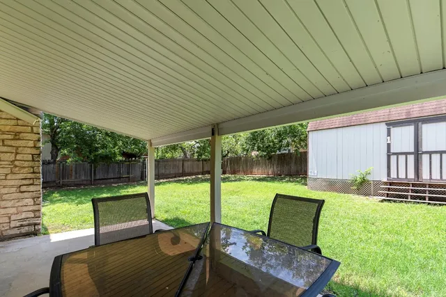 a view of a backyard with couches plants and large garden