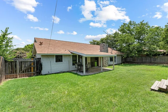 a view of a house with a yard balcony and sitting area