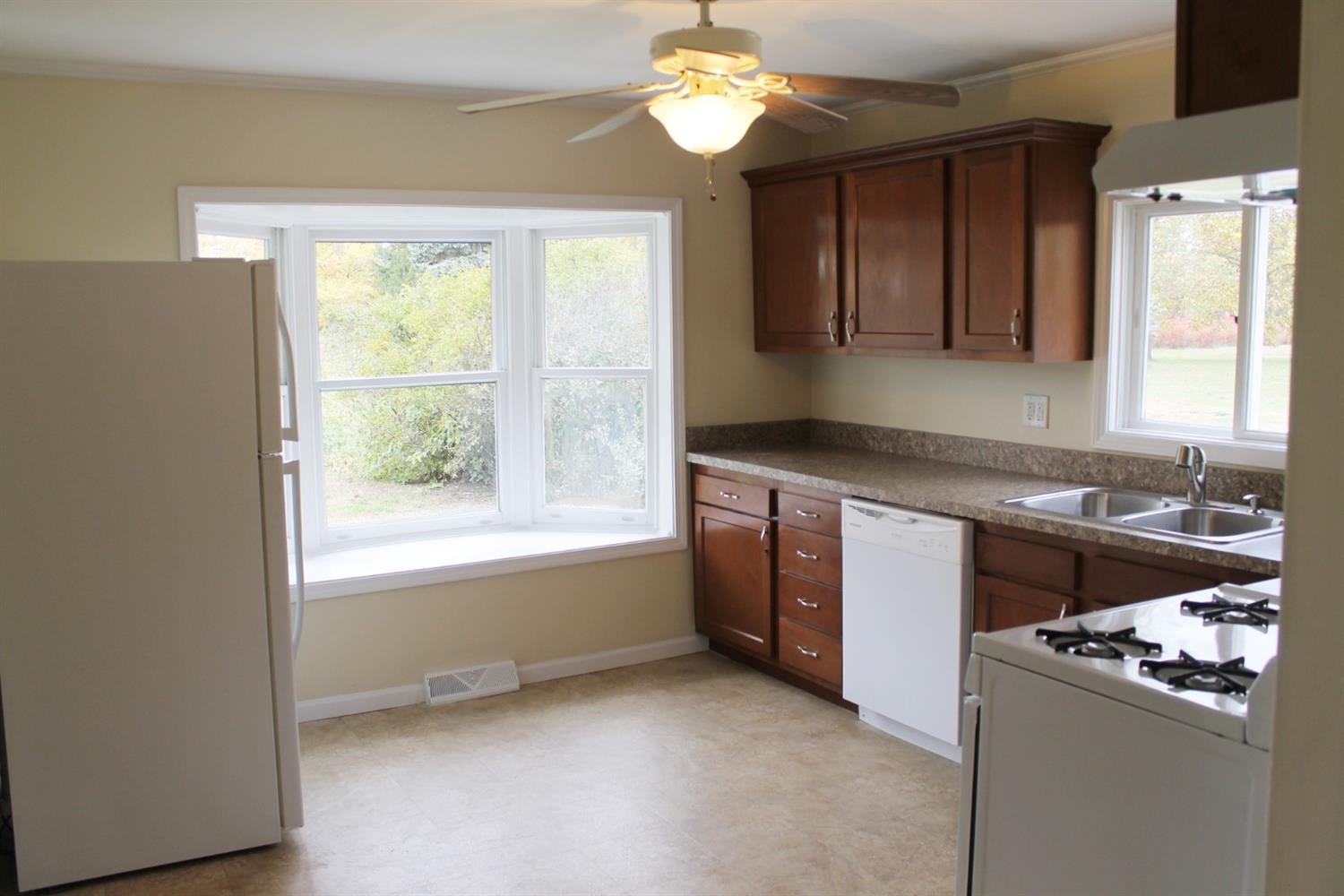 200 8th Avenue Northeast De Motte, IN 46310 - Photo 4 of 22 a kitchen with stainless steel appliances granite countertop a sink and a stove