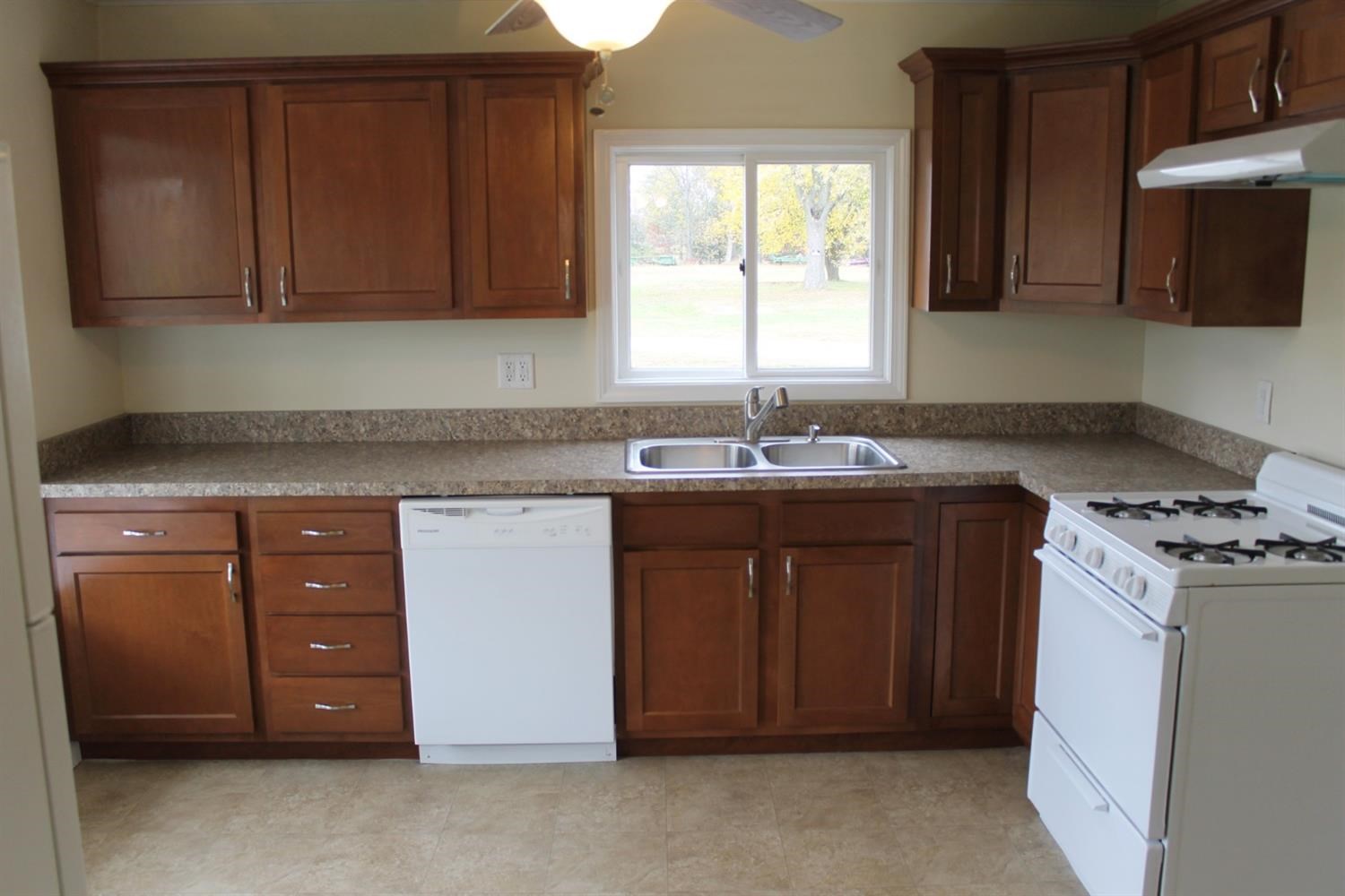 200 8th Avenue Northeast De Motte, IN 46310 - Photo 5 of 22 a kitchen with stainless steel appliances granite countertop a sink stove and cabinets
