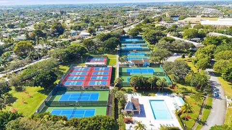 an aerial view of a houses with a swimming pool