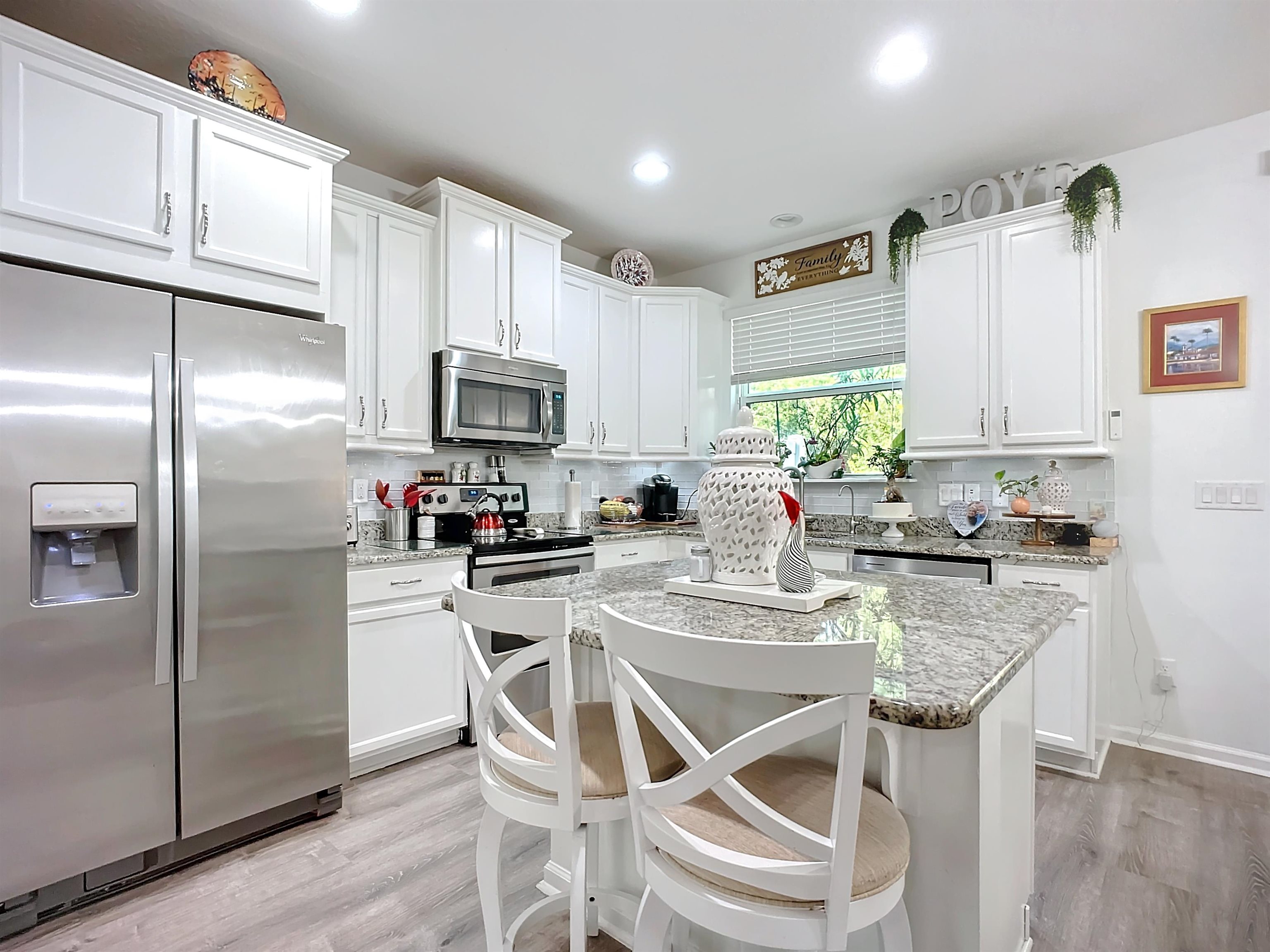 193 Paradas Place St. Augustine, FL 32092 - Photo 11 of 44 a kitchen with stainless steel appliances granite countertop a refrigerator a sink a stove a dining table and chairs