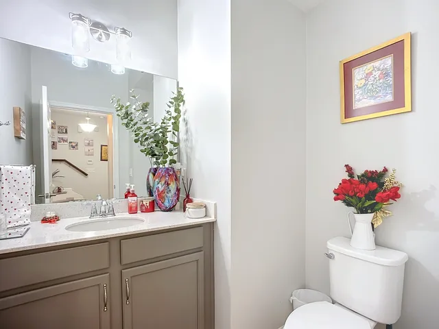 a bathroom with a toilet sink and mirror