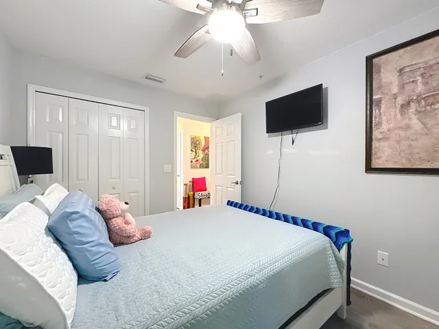 a bedroom with a bed and a flat screen tv
