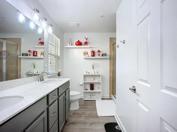 a bathroom with a sink vanity mirror and toilet