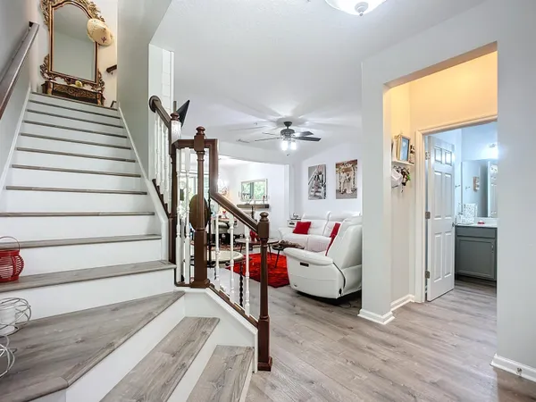 a living room with furniture and wooden floor