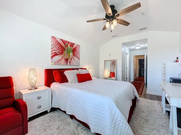 a bed room with a bed and a chandelier