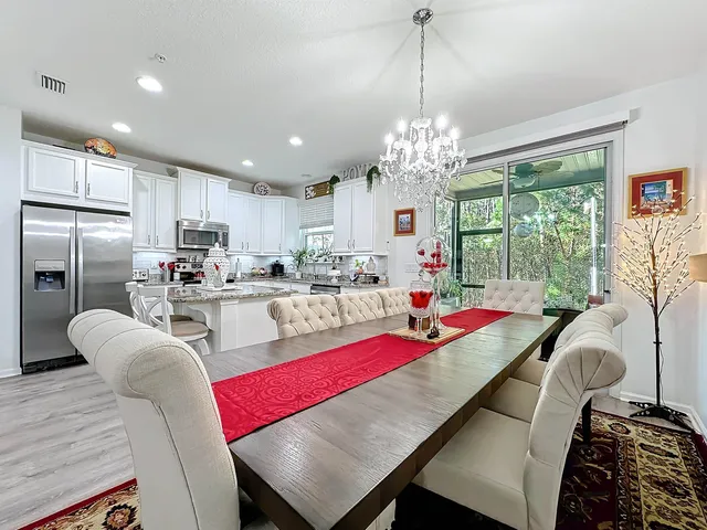 a living room with dining room and kitchen view