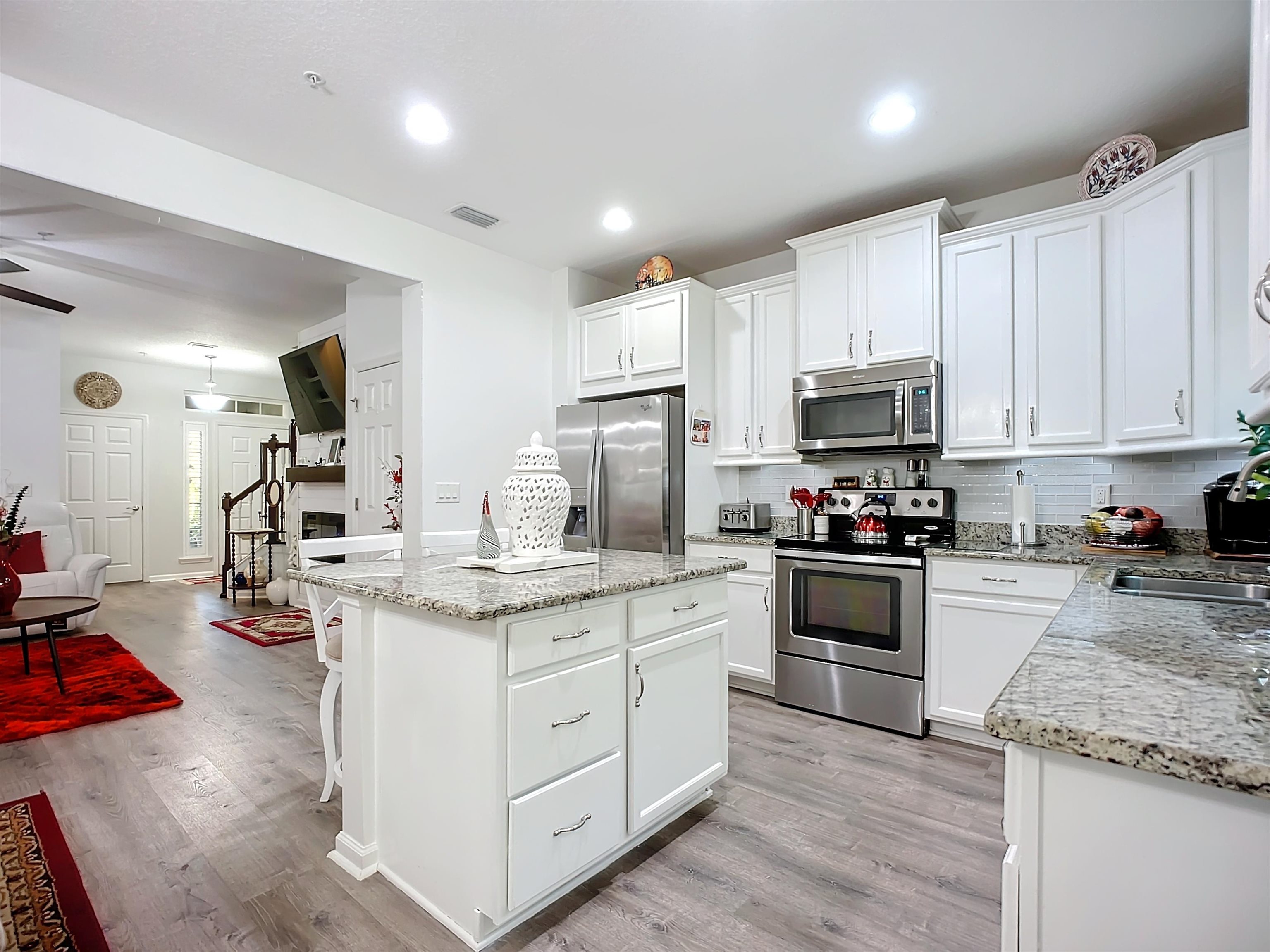 193 Paradas Place St. Augustine, FL 32092 - Photo 9 of 44 a kitchen with kitchen island granite countertop white cabinets and stainless steel appliances
