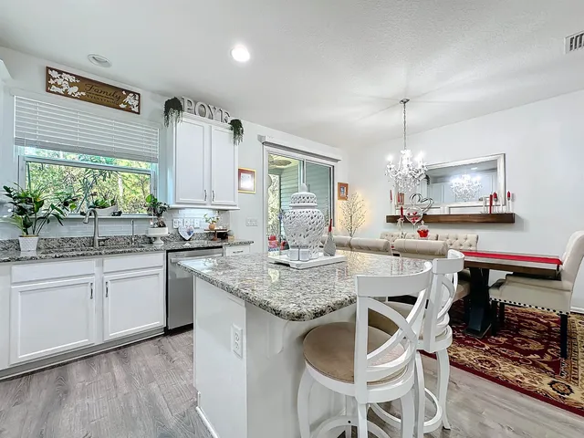 a kitchen with a table chairs stove and cabinets