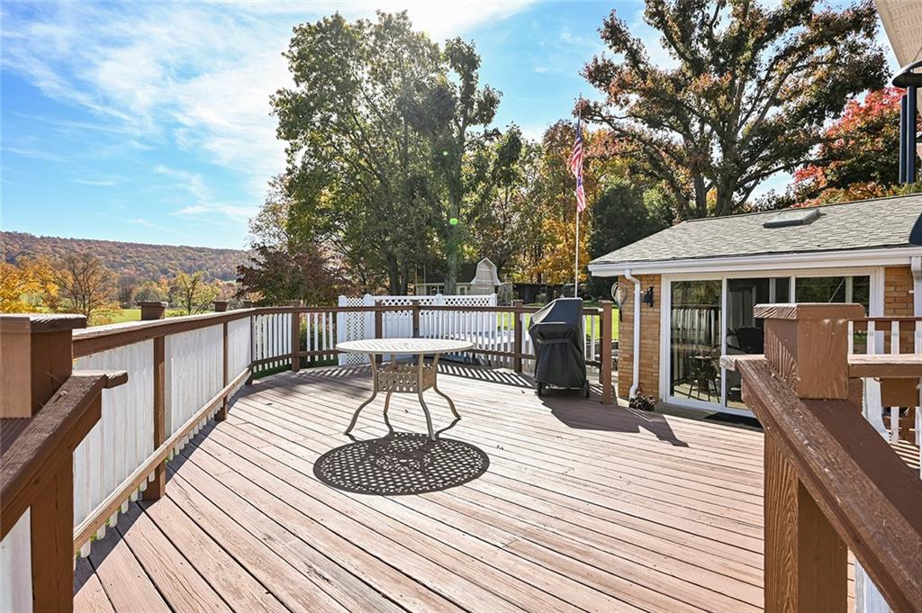 934 Pleasant Valley Road Mount Pleasant, PA 15666 - Photo 20 of 25 a balcony with wooden floor table and chairs