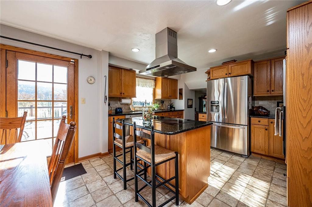 934 Pleasant Valley Road Mount Pleasant, PA 15666 - Photo 4 of 25 a kitchen with stainless steel appliances granite countertop a refrigerator a stove top oven and a refrigerator