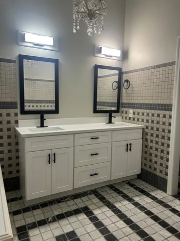 a bathroom with a double vanity sink mirror and