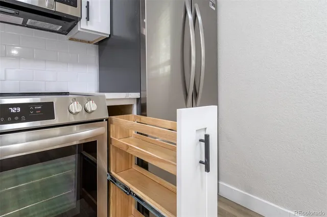 a kitchen with a stove and a refrigerator