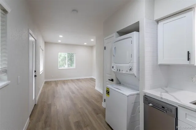 a room with a sink and wooden floor