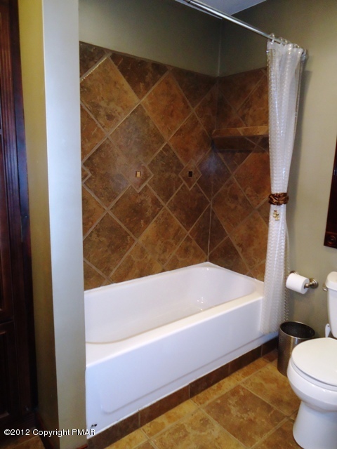 1415 Davids Road Effort, PA 18330 - Photo 12 of 35 a bathroom with a bathtub and shower