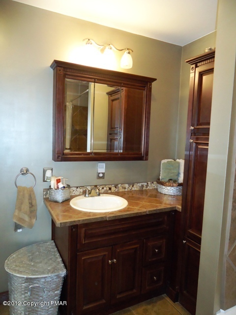 1415 Davids Road Effort, PA 18330 - Photo 13 of 35 a bathroom with a granite countertop sink and a mirror