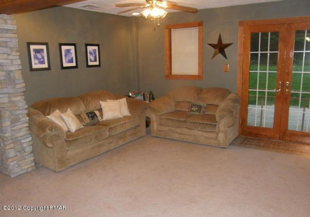 1415 Davids Road Effort, PA 18330 - Photo 16 of 35 a living room with furniture and a chandelier