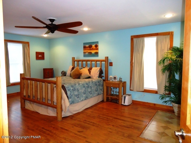 1415 Davids Road Effort, PA 18330 - Photo 19 of 35 a bedroom with a bed and a chandelier