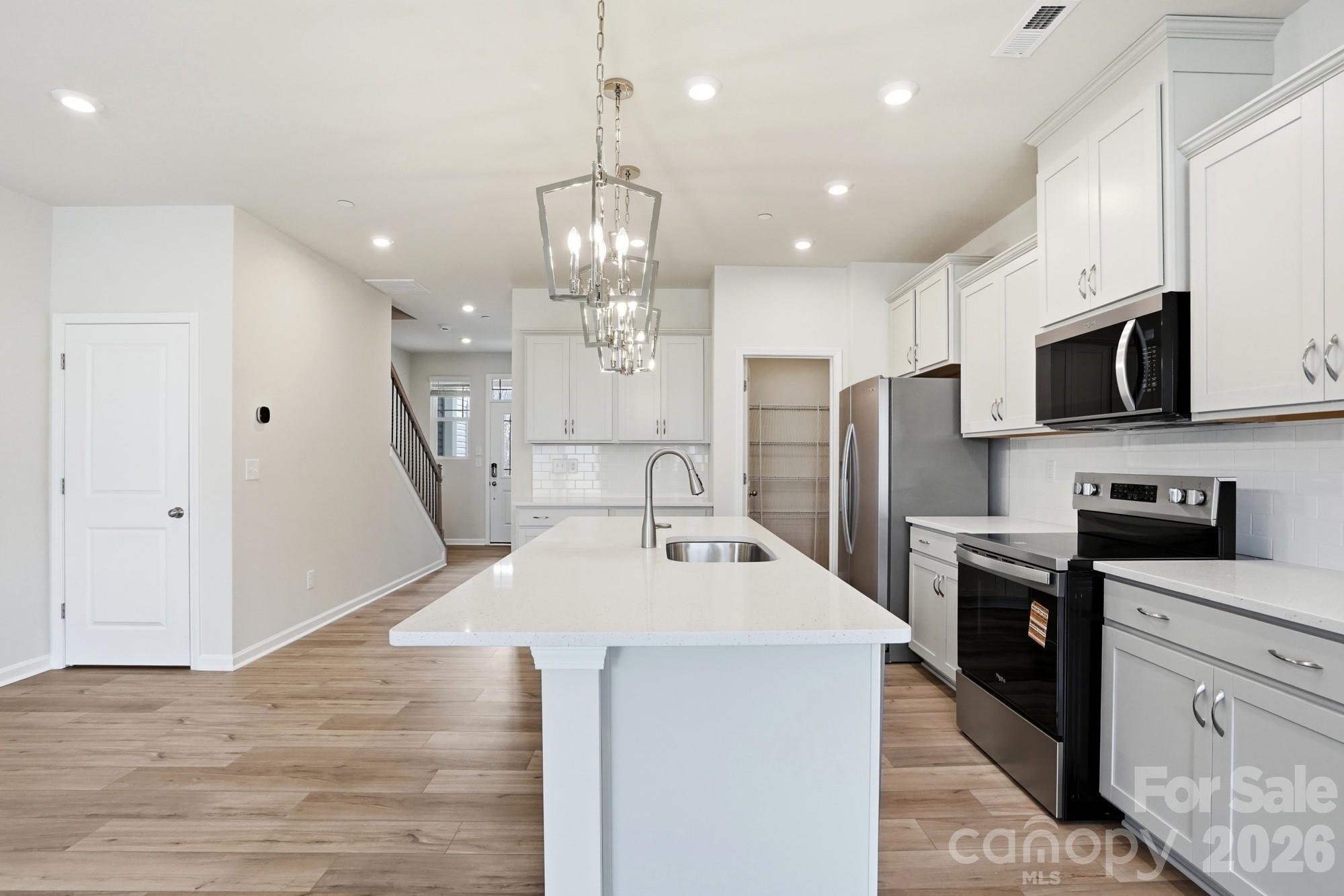 2540 Hedgecliff Road Kannapolis, NC 28083 - Photo 6 of 22 a large kitchen with stainless steel appliances kitchen island granite countertop a sink and cabinets