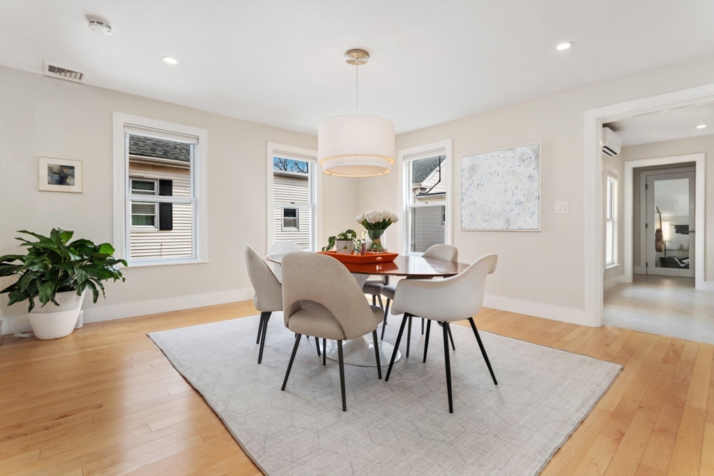 52 Chestnut Street Wakefield, MA 01880 - Photo 13 of 42 a dining room with furniture potted plants and wooden floor