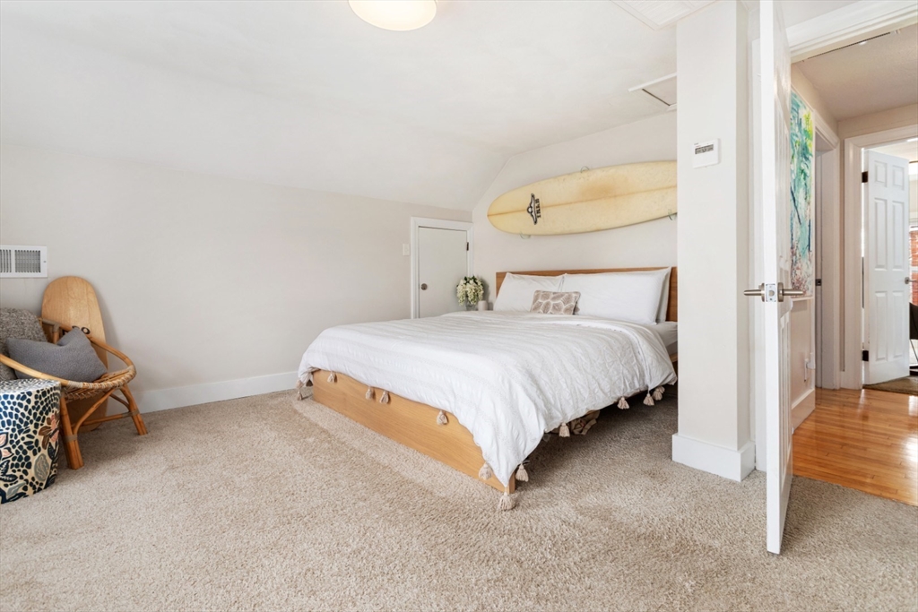 52 Chestnut Street Wakefield, MA 01880 - Photo 21 of 42 a bedroom with a bed a table and painting on the wall