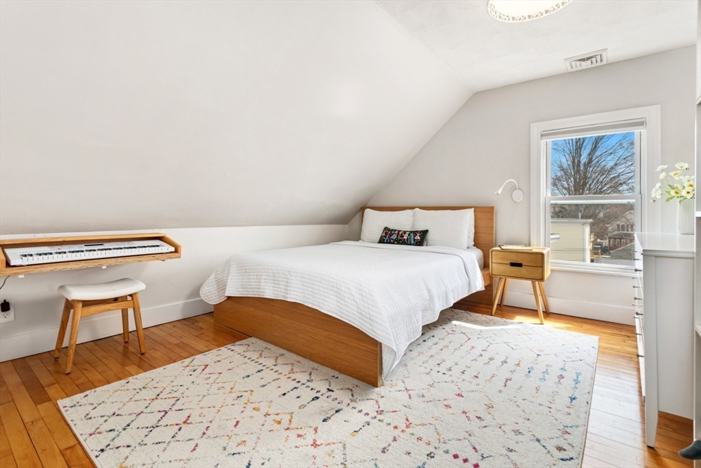 52 Chestnut Street Wakefield, MA 01880 - Photo 23 of 42 a bedroom with a bed and a dresser next to a window