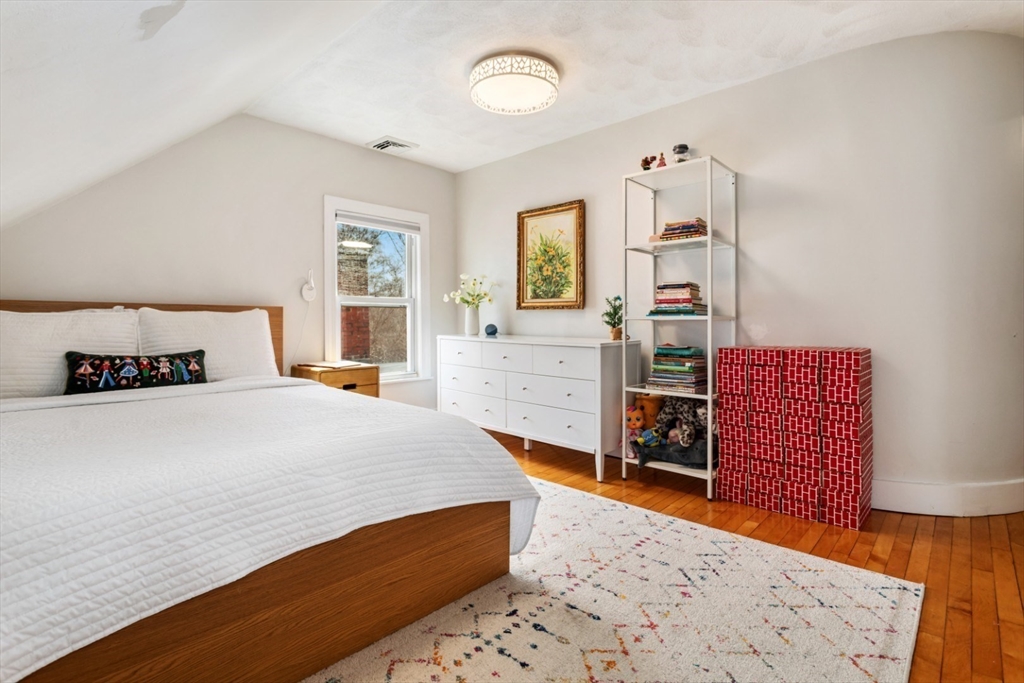 52 Chestnut Street Wakefield, MA 01880 - Photo 24 of 42 a bedroom with a bed and wooden floor